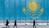 KAZAKHSTAN -- People walk past a gaint Kazakhstan's flag in Astana, March 5, 2019